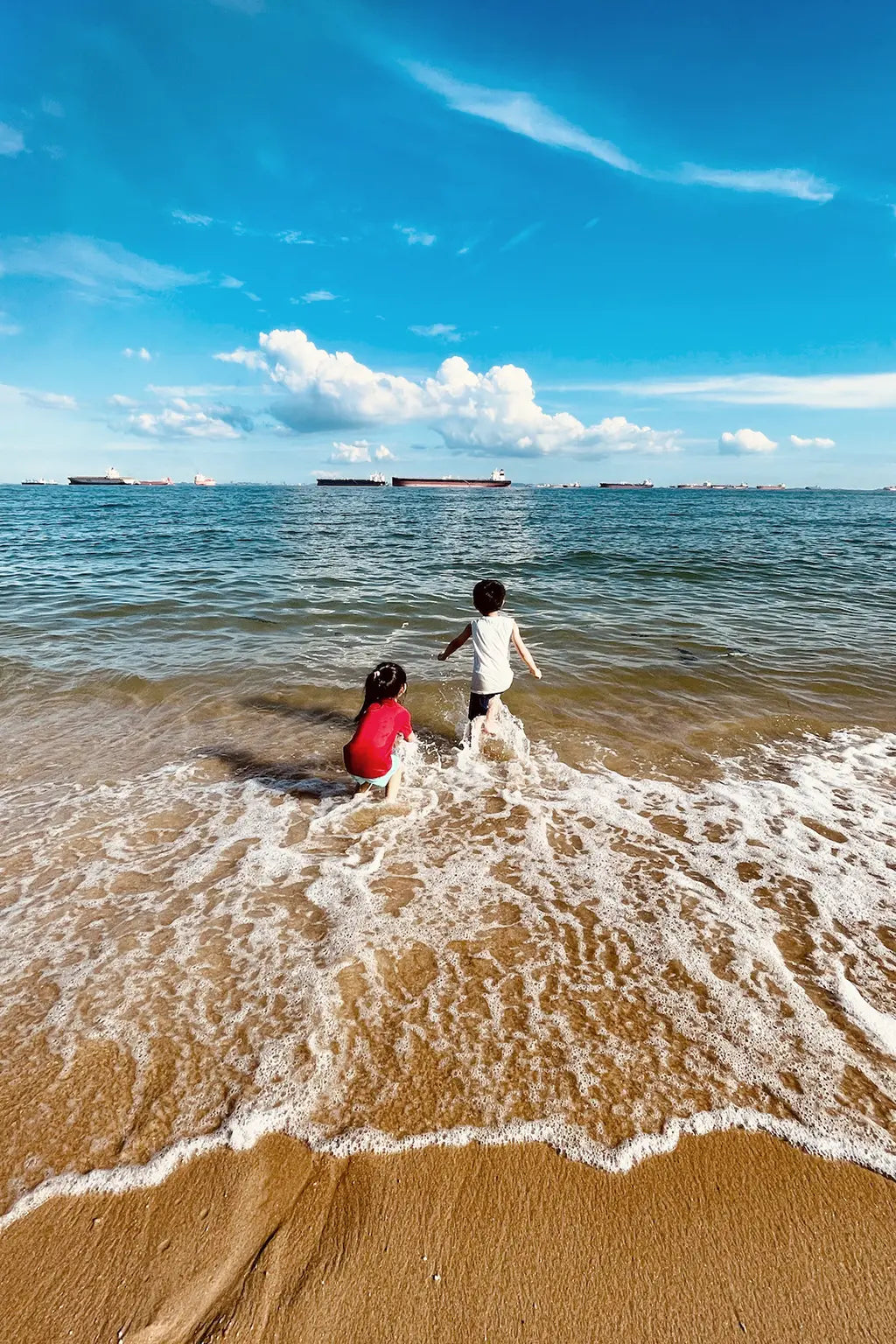 2 children playing at the East Coast beach in Singapore