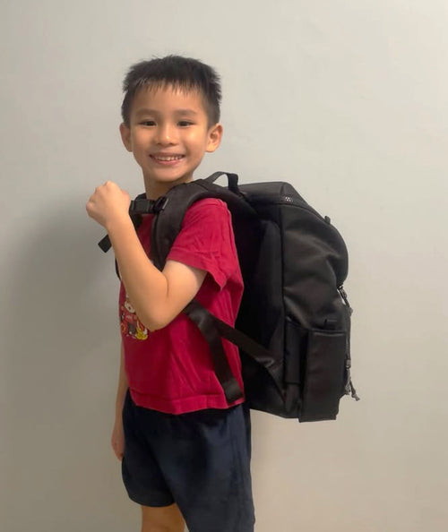 Child with a black backpack