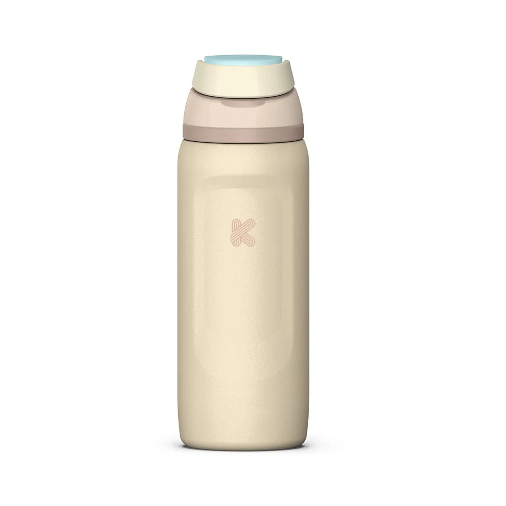 A minimalist insulated water bottle in a warm cream-beige color, featuring a light blue flip-top lid and a subtle pink logo on the front, set against a solid white background.