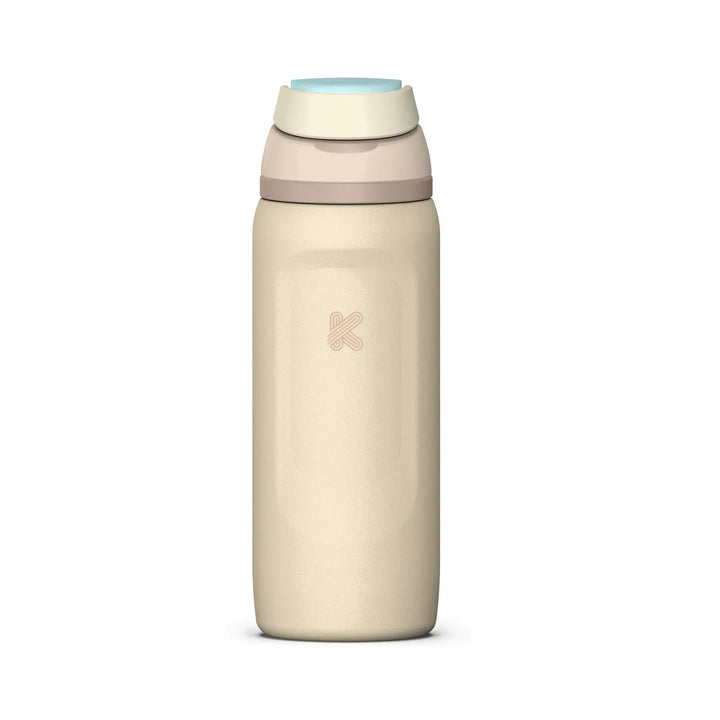 A minimalist insulated water bottle in a warm cream-beige color, featuring a light blue flip-top lid and a subtle pink logo on the front, set against a solid white background.